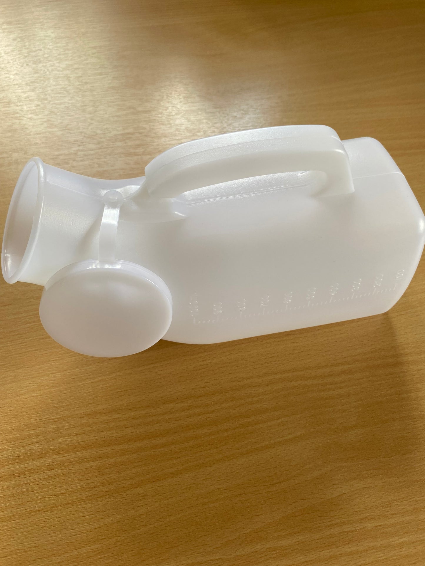 Male urinal with handle