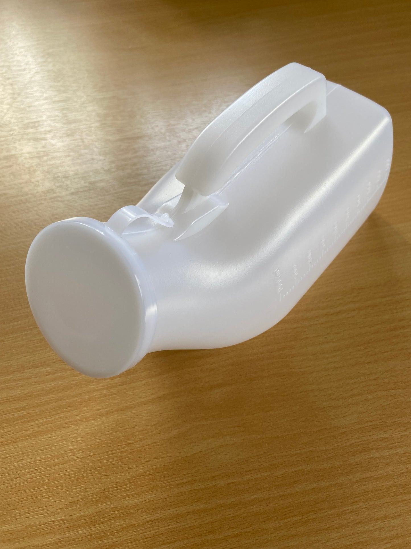 Male urinal with handle